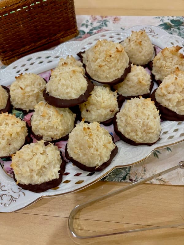 A plate of coconut macaroons dipped in chocolate.