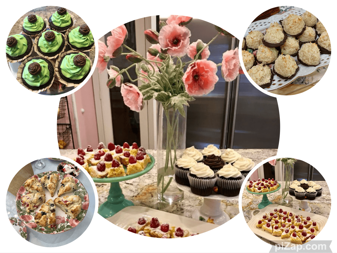 A beautifully arranged display of assorted cupcakes and pastries surrounded by vibrant flowers.