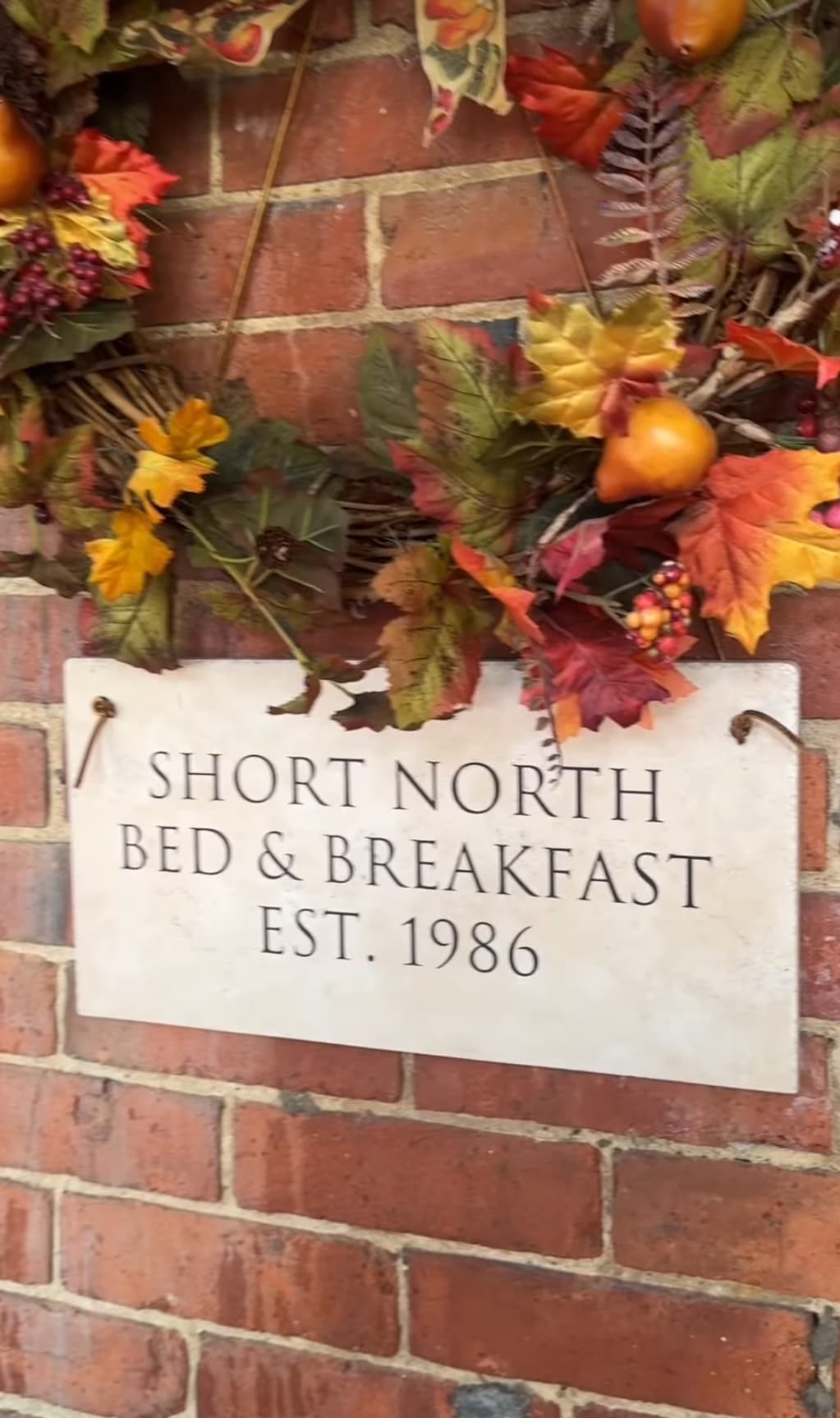Sign of "Short North Bed & Breakfast" with decorative autumn leaves, established in 1986. Sign of "Short North Bed & Breakfast" with decorative autumn leaves, established in 1986.